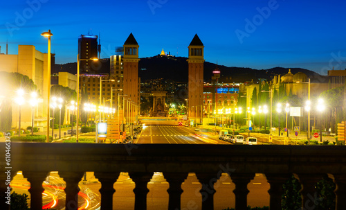 Picturesque Barcelona cityscape in summer twilight overlooking lighted avenue Avinguda de la Reina Maria Cristina with two Venetian Towers at junction with Placa dEspanya, Spain.