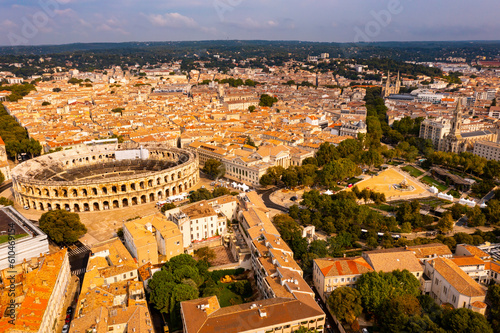 Aerial view of Roman amphitheatre on background with cityscape of Nimes. France
