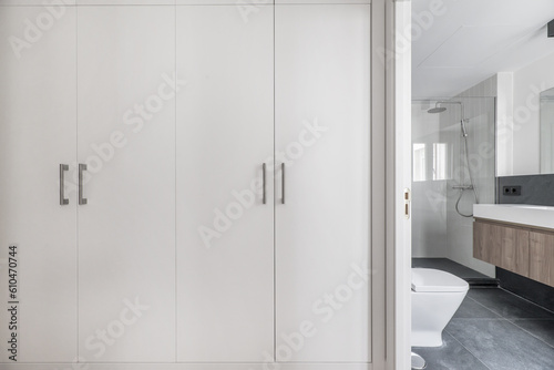 A dressing room with white wooden door