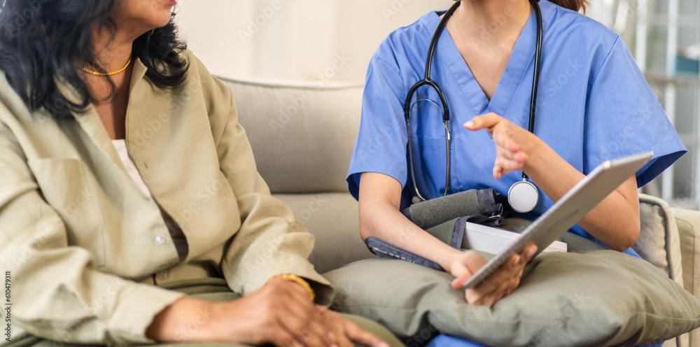 Obraz premium Portrait of asian woman physiotherapist carer helping physical and discussing consulting talk with senior woman patient by doing exercises, caring, caregiver sitting at home.healthcare and medicine