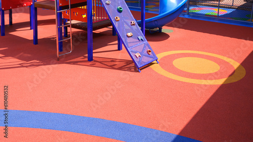 Colorful rubber floor with outdoor playground equipment at kindergarten school