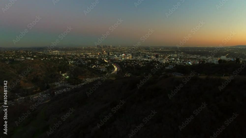 Aerial Shot Of Suburb Near Downtown Against Orange Sky At Dusk, Drone Descending Over Neighborhood In City - Los Angeles, California Aerial Shot Of Suburb Near Downtown Against Orange Sky At Dusk, Drone Descending Over Neighborhood In City - Los Angeles, California