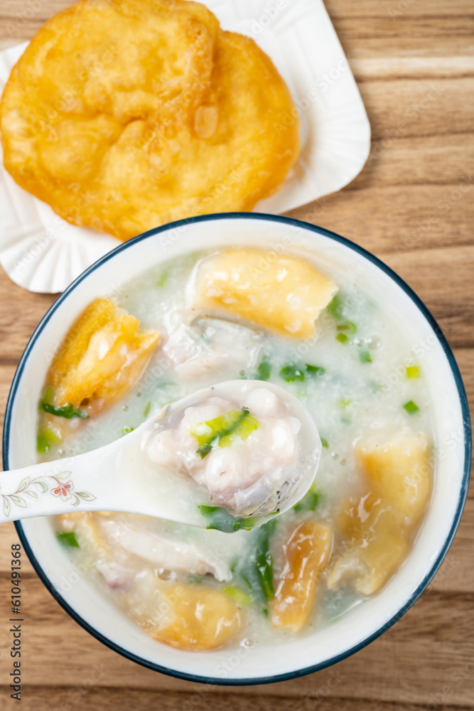 top view fish porridge with deep-fried Chinese donuts at vertical composition top view fish porridge with deep-fried Chinese donuts at vertical composition