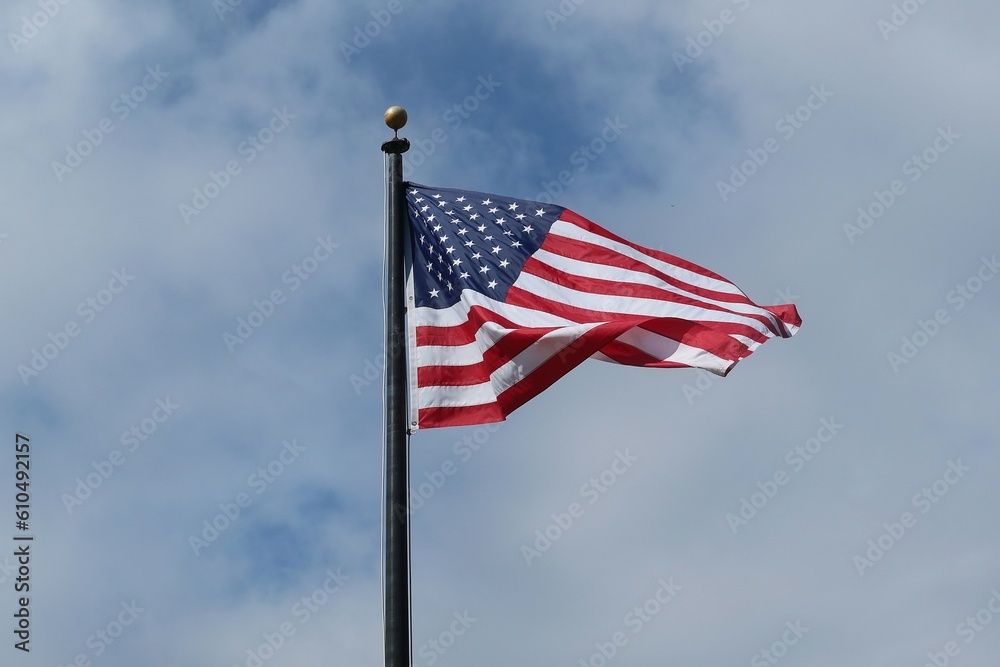Fototapeta premium American flag on blue sky background