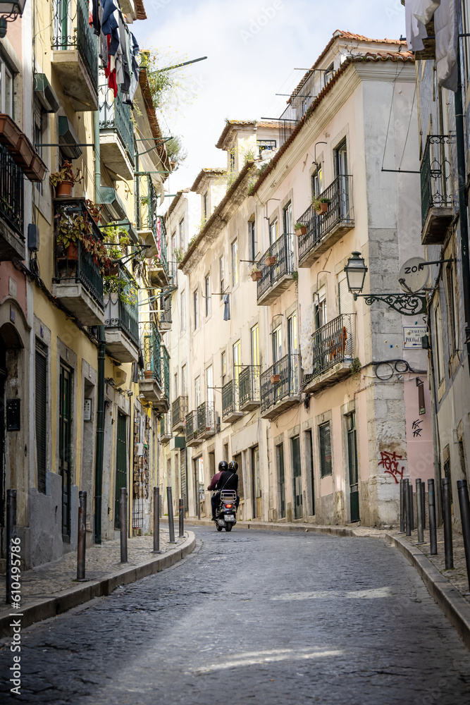 Motorcycle driving down a cobblestone street in Europe