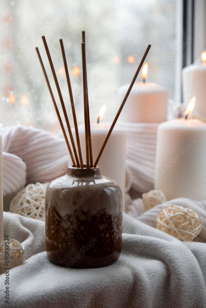 Aroma reed diffuser. Bottle container with wood stick diffusers Essential  oils to scent your home fragnance concept autumn holidays at cozy home on  the windowsill Hygge aesthetic atmosphere on knitted Photos