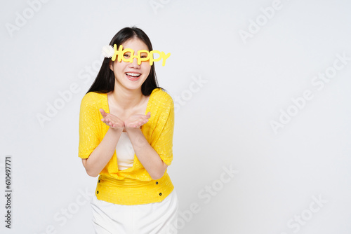 Happy young woman presenting or showing open hand palm with copy space for product isolated on white background.