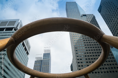 Focus at the high building at Fountain of Wealth in daytime at Singapore is recognized as the largest fountain. Traffic on a circle road with high business building background.