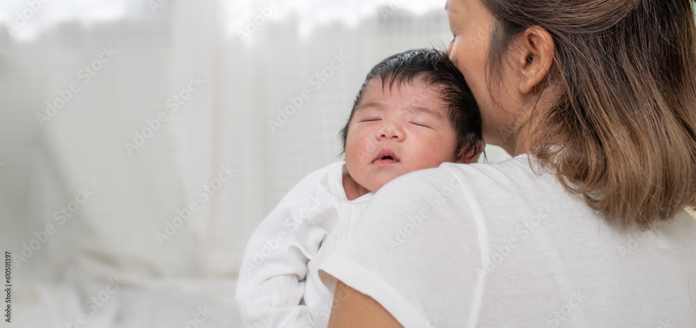 happy loving family. mother playing with her baby hugging in the bedroom , portrait of asian mother playing with newborn baby, health care family love together. asian girl lifestyle.. happy loving family. mother playing with her baby hugging in the bedroom , portrait of asian mother playing with newborn baby, health care family love together. asian girl lifestyle..