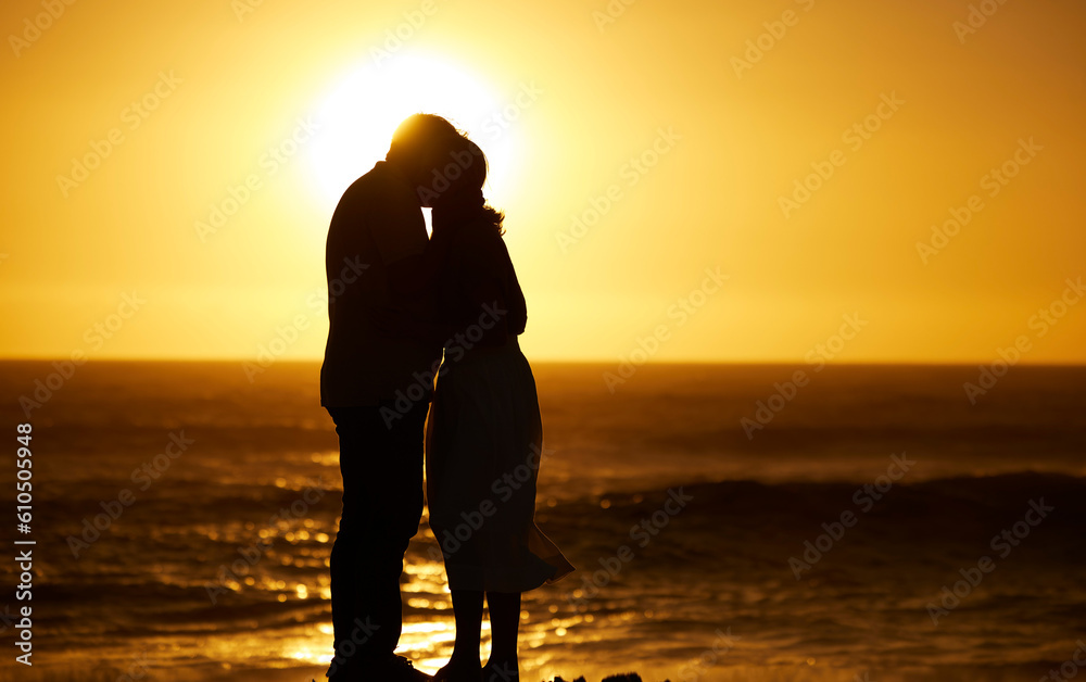 Couple, siilhouette and kiss at sunset on a beach for vacation, holiday or mockup outdoor. Romantic man and woman in nature with creative sky, care and ocean for love, shadow art and travel freedom