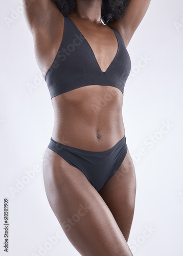 Body, fitness and beauty with black woman in studio for nutrition, weight loss and diet. Health, wellness and abdomen muscle with closeup of female model on white background for self care and glow