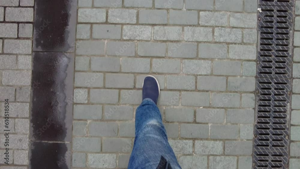 POV shot of man in shoe walking on road POV shot of man in shoe walking on road