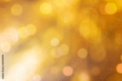 Blurred gold sparkles, defocused celebration lights.