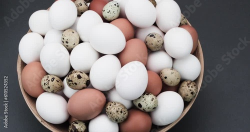 The hand takes the egg from the basket