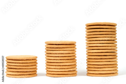 Columns of different heights made of cookies on a white background. Stacks of cookies isolated on a white background. photo