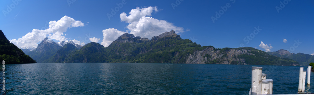 Scenic wide angle view of Lake Uri with beautiful mountain panorama and villages Bauen and Seelisberg in the background on a sunny spring day. Photo taken May 22nd, 2023, Sisikon, Switzerland.