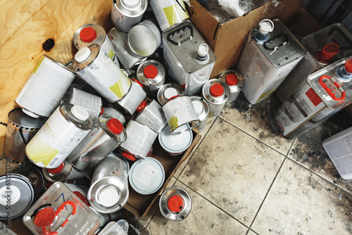 Industrial metal cans with paint and technical liquid in storeroom