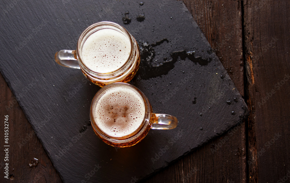 top view glass mugs with beer on wooden table