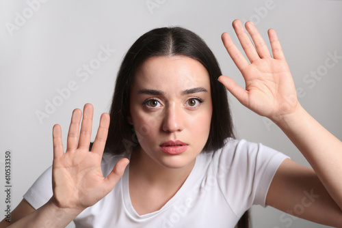 Young woman stuck to transparent screen. Internet addiction