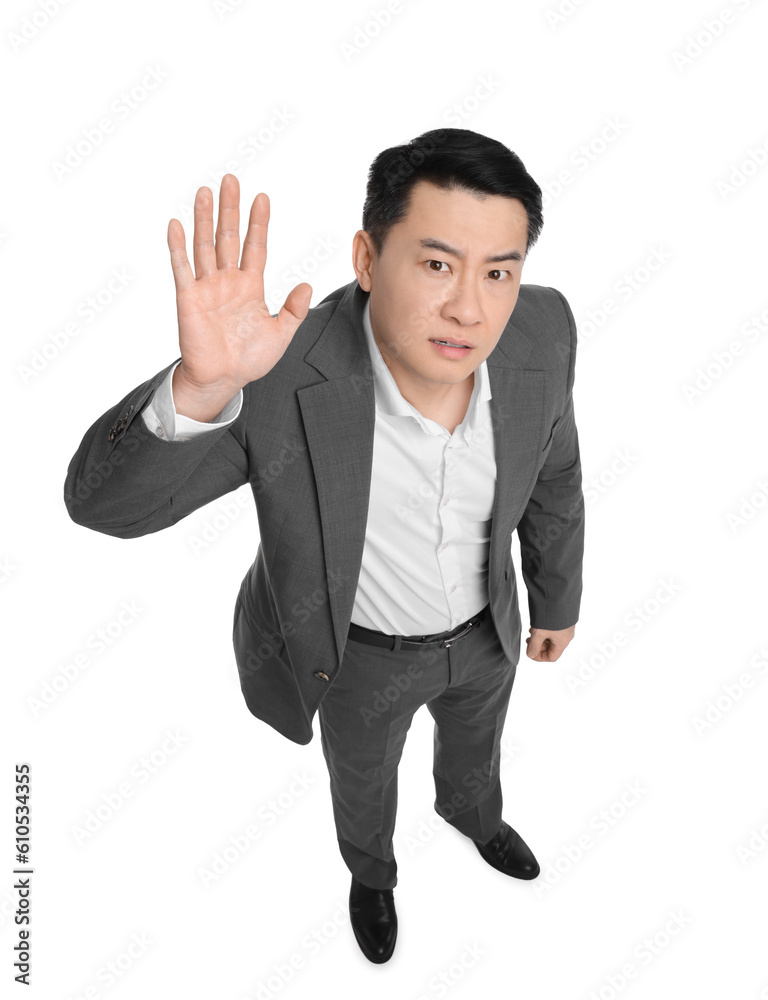 Angry businessman in suit posing on white background, above view Angry businessman in suit posing on white background, above view