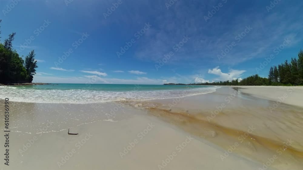 A river flowing into the sea through a sandy beach. Borneo, Malaysia. Kalampunian Beach. A river flowing into the sea through a sandy beach. Borneo, Malaysia. Kalampunian Beach.