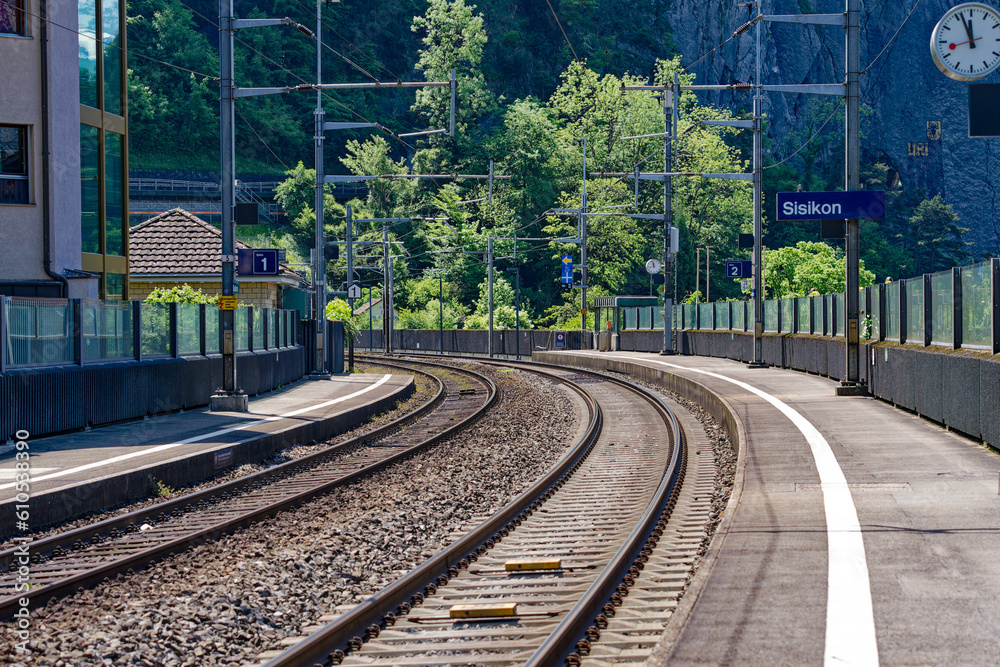 Close-up of railway tracks with curve at railway station of village Sisikon on a sunny spring noon. Photo taken May 22nd, 2023, Sisikon, Canton Uri, Switzerland.