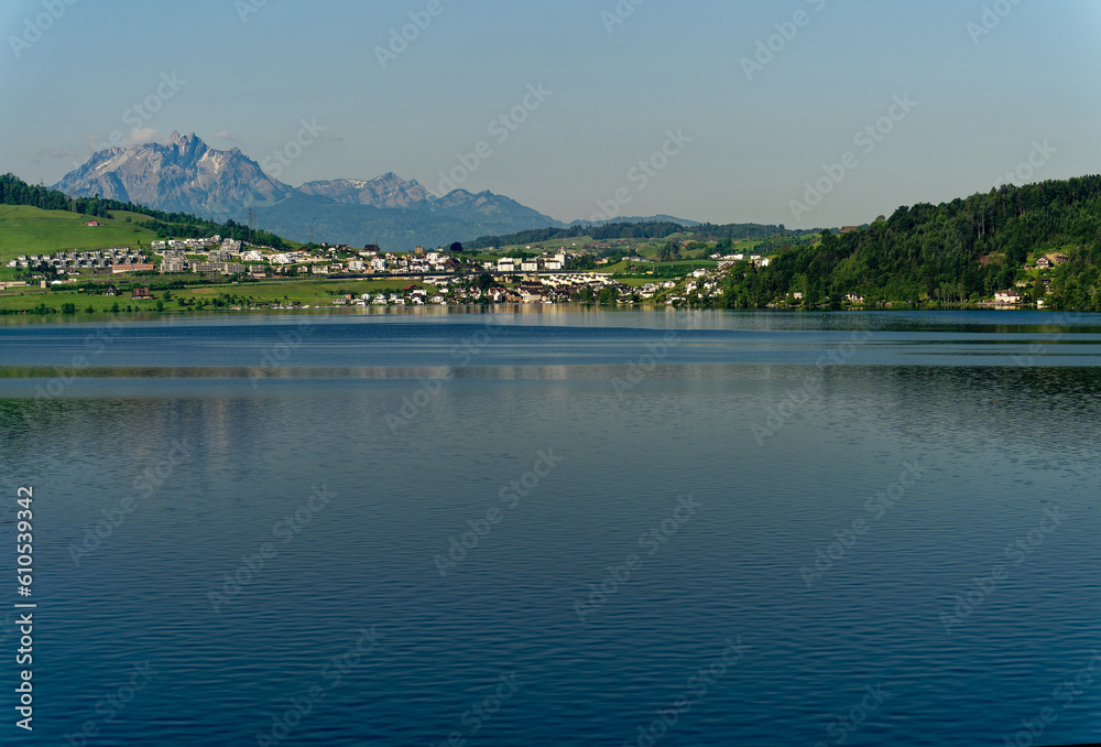 Scenic view of Swiss Lake Zug on a sunny spring day with famous Mount Pilatus in the background. Photo taken May 22nd, 2023, Lake Zug, Switzerland.