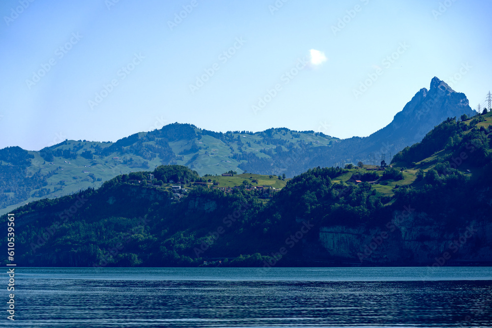 Scenic view of Lake Lucerne with mountain panorama in the background on a sunny spring day. Photo taken May 22nd, 2023, Sisikon, Switzerland.