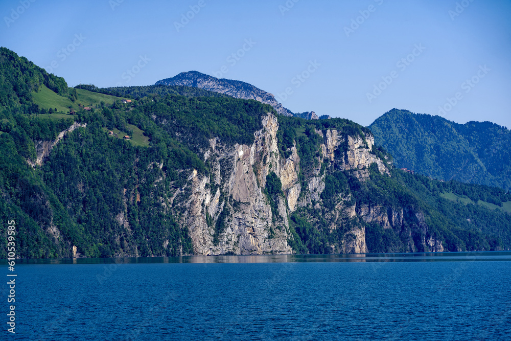 Scenic landscape with Lake Lucerne and mountain panorama in the Swiss Alps on a sunny spring day. Photo taken May 22nd, Sisikon, Canton Uri, Switzerland. Scenic landscape with Lake Lucerne and mountain panorama in the Swiss Alps on a sunny spring day. Photo taken May 22nd, Sisikon, Canton Uri, Switzerland.