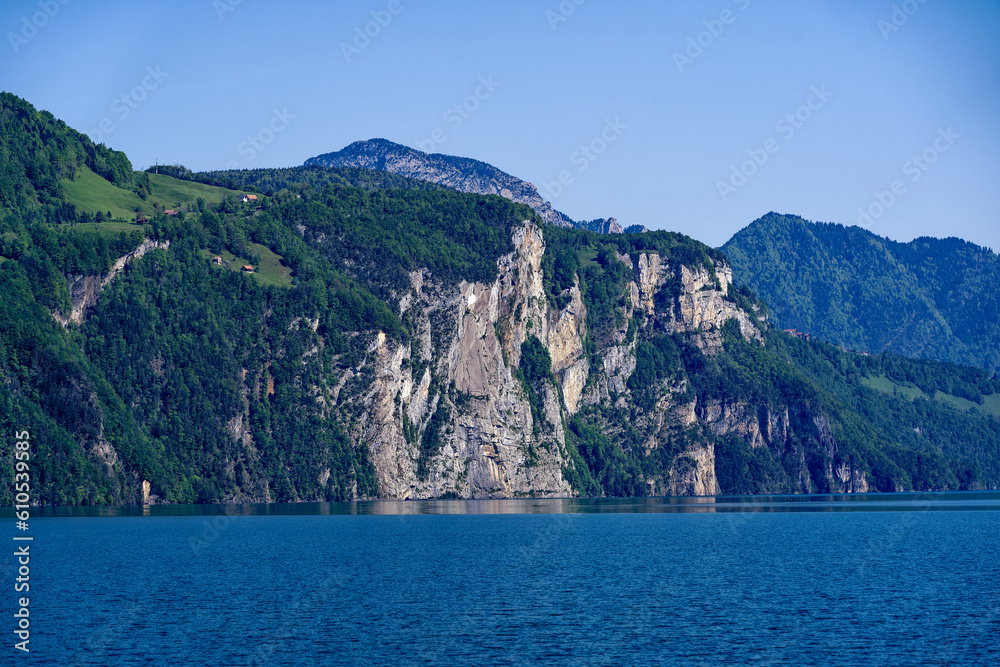 Scenic landscape with Lake Lucerne and mountain panorama in the Swiss Alps on a sunny spring day. Photo taken May 22nd, Sisikon, Canton Uri, Switzerland.