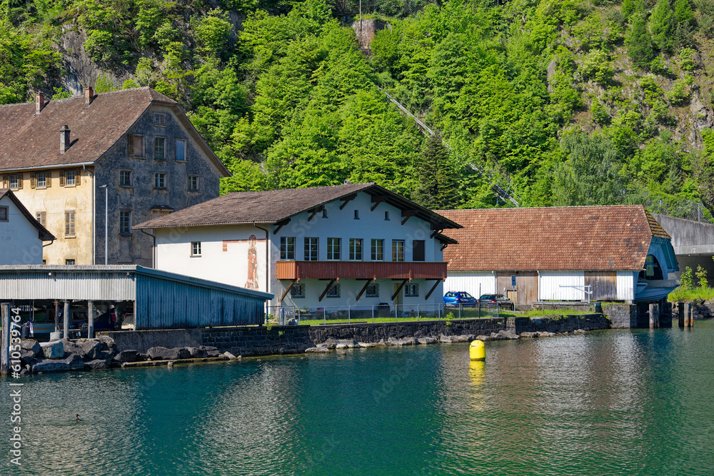 Scenic view boat house with Lake Lucerne in the foreground on a sunny spring day. Photo taken May 22nd, Isleten, Canton Uri, Switzerland.