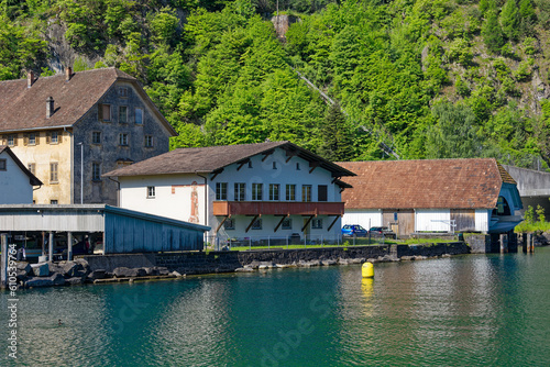 Scenic view boat house with Lake Lucerne in the foreground on a sunny spring day. Photo taken May 22nd, Isleten, Canton Uri, Switzerland.