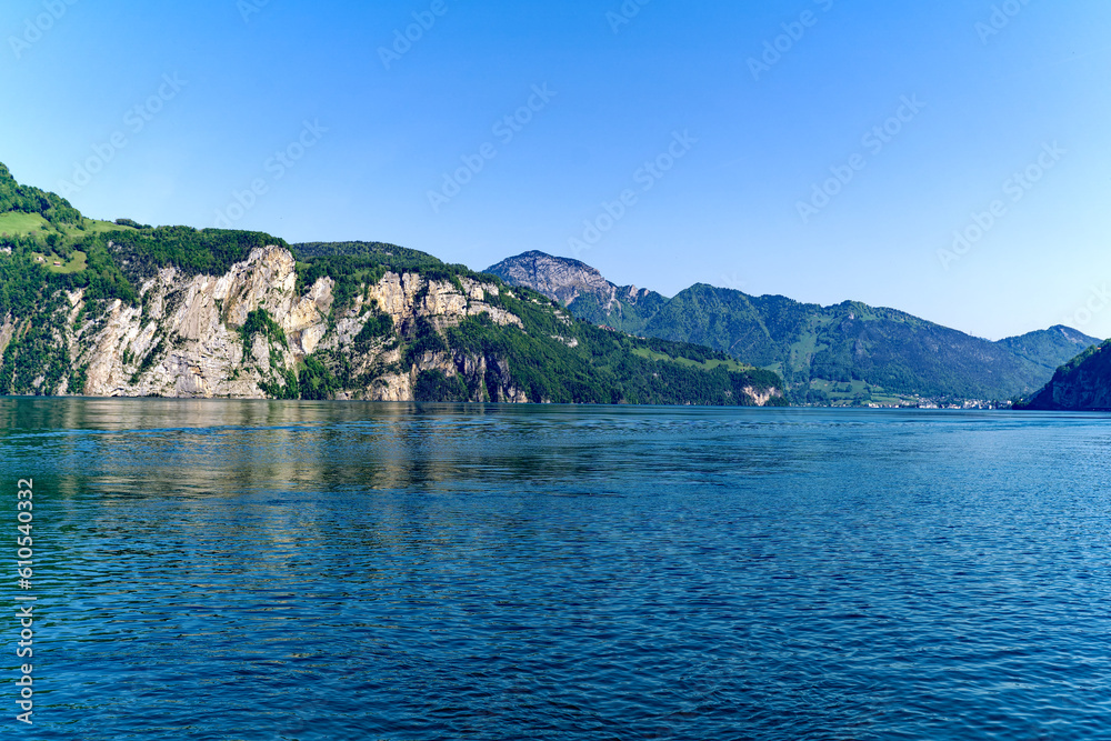 Scenic landscape with Lake Lucerne and mountain panorama in the Swiss Alps on a sunny spring day. Photo taken May 22nd, Sisikon, Canton Uri, Switzerland.