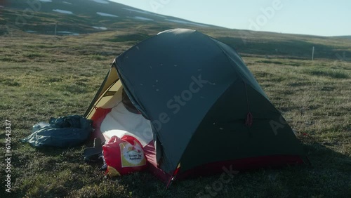 Mosquitoes Swarning Around a Hiker Tent in a Beautiful Sunset Evening Atmosphere, Flying in the Sunrays photo