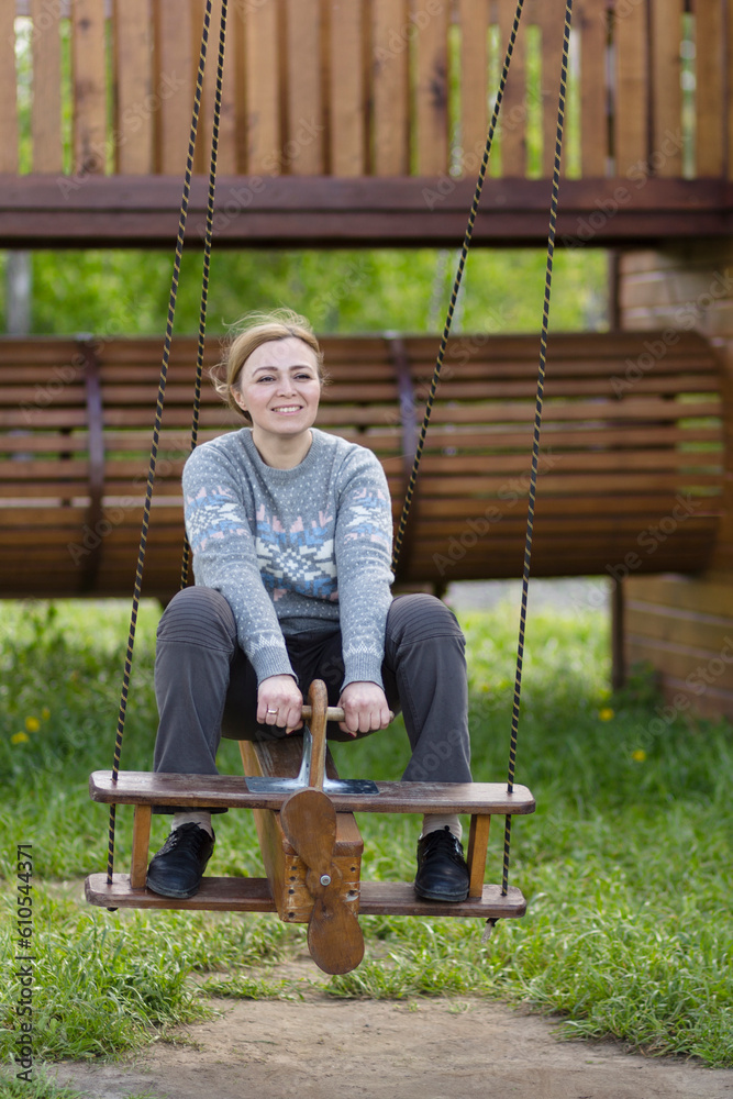 Fototapeta premium Woman on swing at playground.