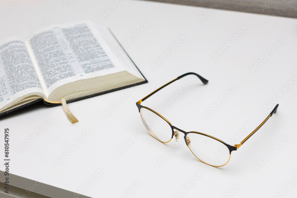 reading glasses lie on the table near the book reading glasses lie on the table near the book