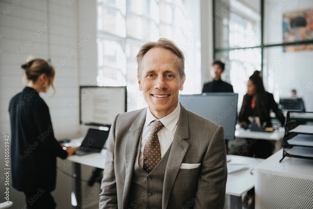 Portrait of smiling mature businessman wearing suit at office Portrait of smiling mature businessman wearing suit at office