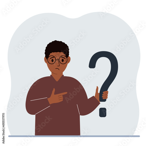 A man is holding a question mark symbol. Ask questions and look for answers. FAQ or frequently asked questions concept, online support center.