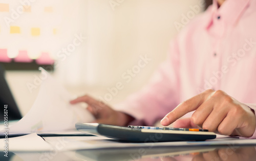 The businessman hand sits at their desks and calculates financial graphs showing the results of their investments planning the process of successful business growth © Orathai