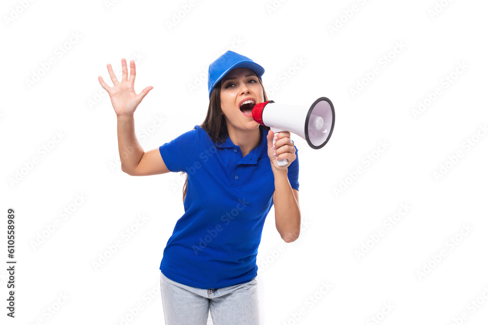 pretty well-groomed young promoter woman in a blue cotton t-shirt and cap uses a loudspeaker to announce promotional offers pretty well-groomed young promoter woman in a blue cotton t-shirt and cap uses a loudspeaker to announce promotional offers