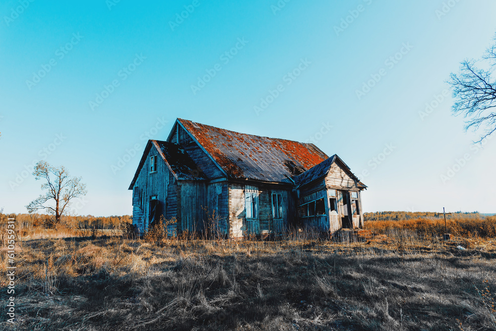 Abandoned 19th century house in a rural field at summer.Creepy summer evening.Toned. Abandoned 19th century house in a rural field at summer.Creepy summer evening.Toned.