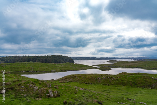 Panorama of the beautiful landscape of the island of Karmoy in Rogaland, Norway, with dark cloudy sky photo