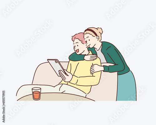 Smiling couple using the tablet pc. Hand drawn style vector design illustrations.