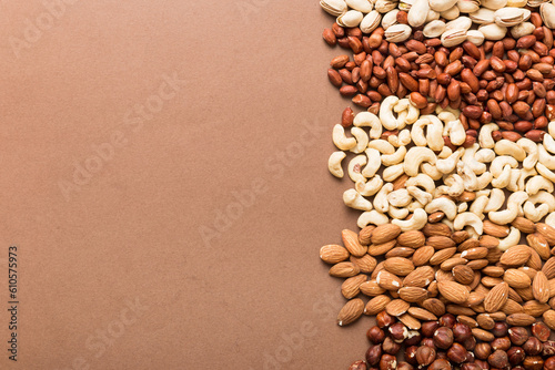different nuts frame background. Close up, top view, flat lay with vopy space. Walnut, pistachios, almonds, hazelnuts and cashews