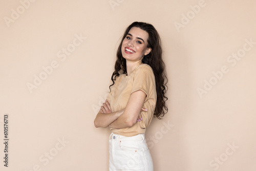 Healthy woman holding hand against beige background