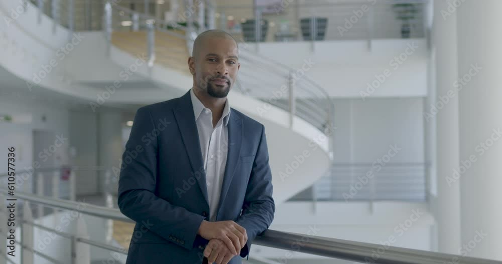 Portrait of Successful African American Businessman Standing in Office Lobby Portrait of Successful African American Businessman Standing in Office Lobby