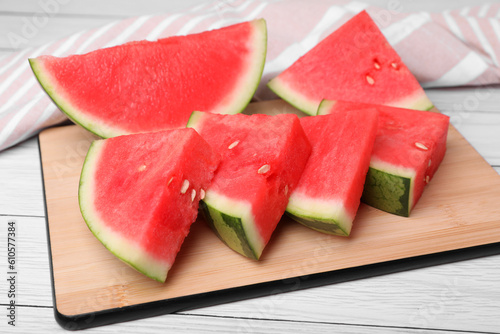 Pieces of juicy ripe watermelon on white wooden table, closeup