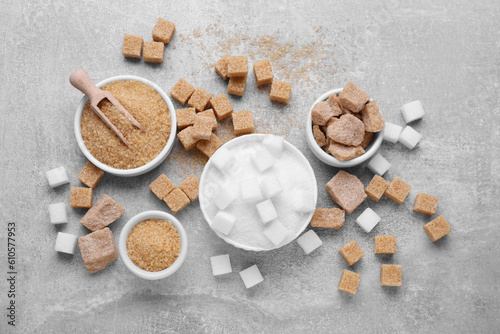 Different types of sugar on grey table, flat lay