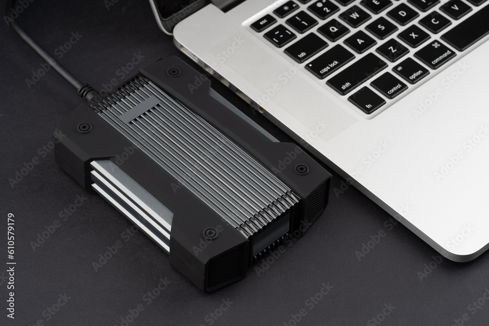 External USB hard drive isolated on white background. Waterproof protected external hard drive. Hard disk for connecting to a laptop, transferring data between a computer and a hard disk. External USB hard drive isolated on white background. Waterproof protected external hard drive. Hard disk for connecting to a laptop, transferring data between a computer and a hard disk.