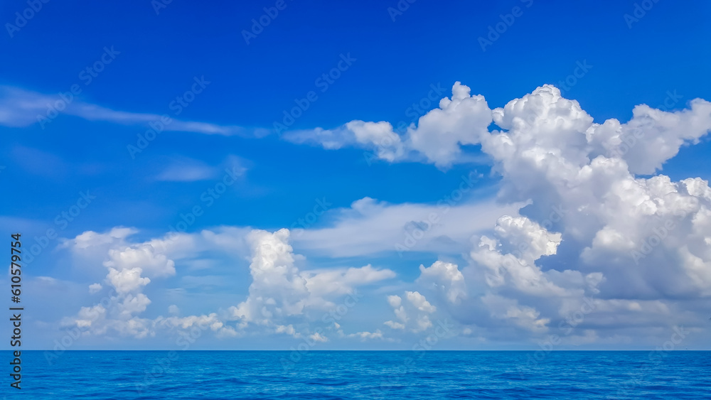 White fluffy clouds with blue sky and little island landscape background	